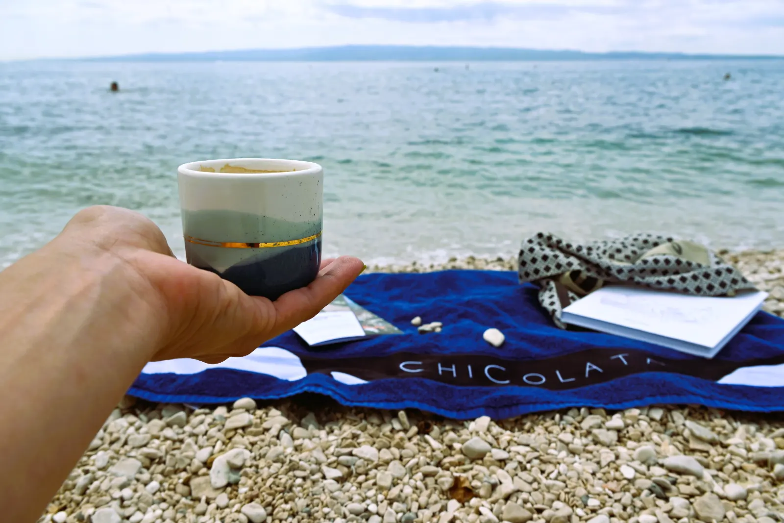 Coffee and a towel on the rocks by the sea at Bačvice