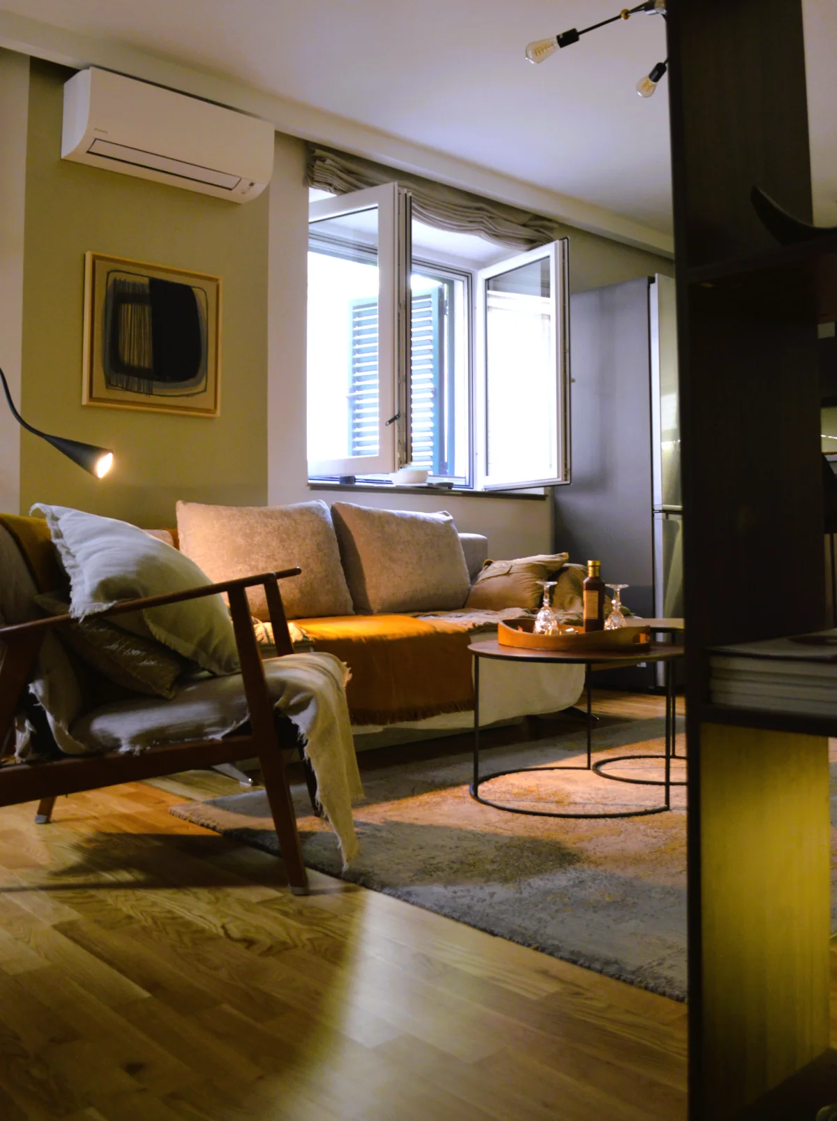 The living room at ChiColata, with the window open onto a green shutter
