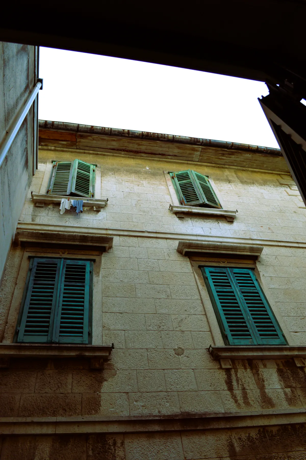 A Split stone facade with green shutters