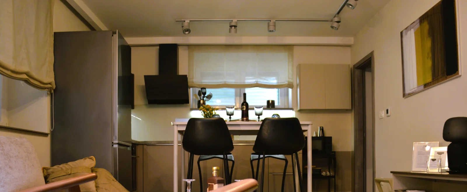 The open-plan interior: kitchen with a bar table, and the living area